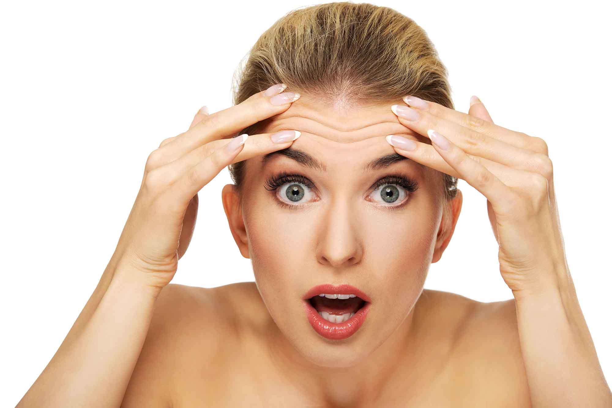 A young woman checking wrinkles on her forehead